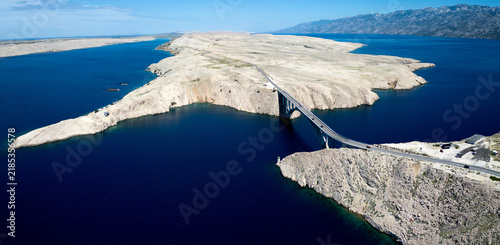 Fotografie Aerial View of Pag Bridge and Rugged Coastline of Pag Island, Croatia