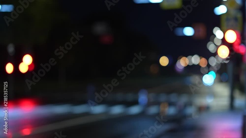 Nighttime urban intersection with blurred vehicle lights and city atmosphere, creating a cinematic background for transportation, technology and modern lifestyle content