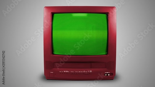 Old red TV on a light background with a green screen. CRT screen of a vintage TV. Looping animation.