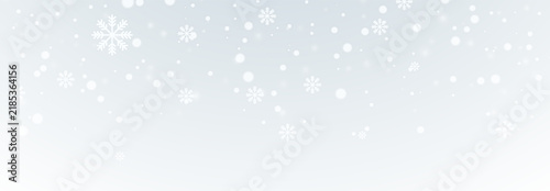 Soft falling snow with ice crystals, tiny white dots, and a bright winter glow on a gradient background. Snowflakes fall on a soft gray-white background.