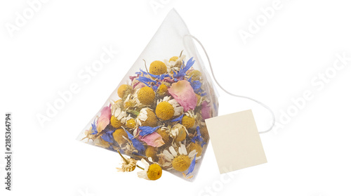 Fotografie Pyramid tea bag with chamomile and floral herbs, premium silk mesh sachet with l