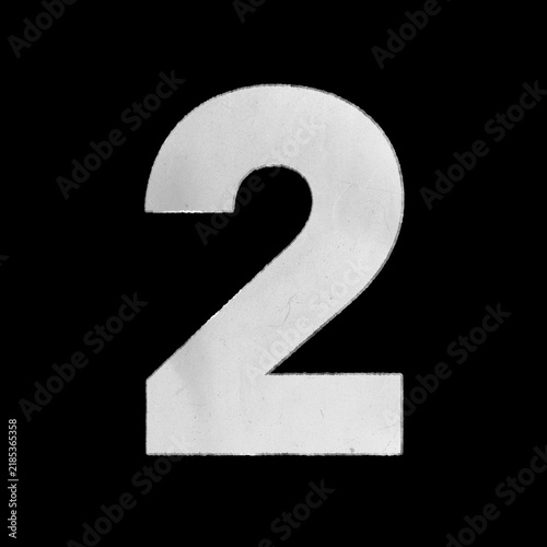 White crumpled paper cutout of the number two isolated on a black background