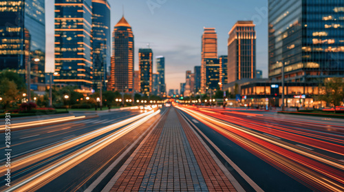 Urban Boulevard With Colorful Light Trails Between Illuminated City Buildings