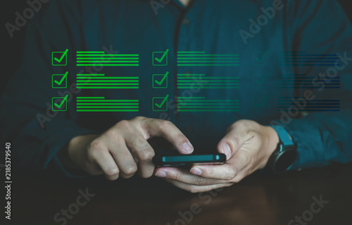 Person using smartphone with virtual checklist interface showing completed green checkmark icons