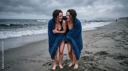 Women sharing towel after swim
