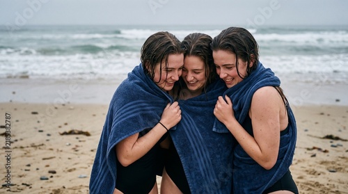 Women sharing towel on beach