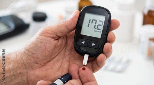 Senior man testing high blood sugar with digital glucometer