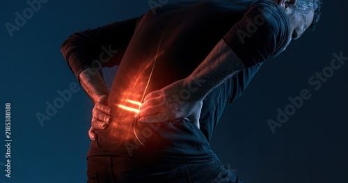 Man Experiencing Severe Lower Back Pain With Red Glow Indicating Discomfort.
