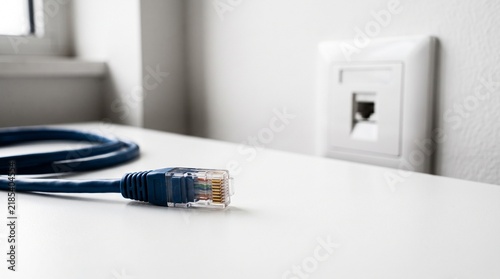 Obraz w ramie Disconnected Ethernet cable beside a network wall socket