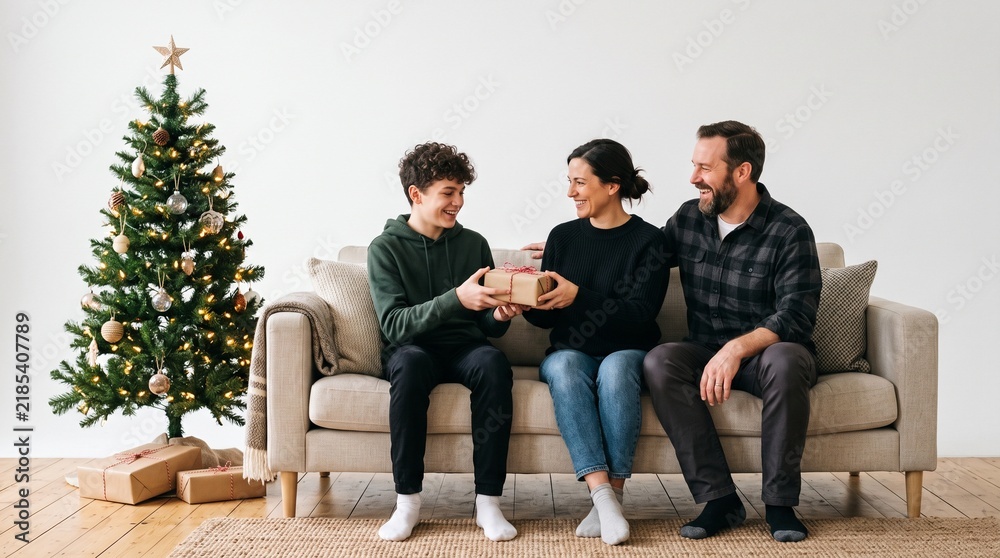 Fototapeta premium Family exchanging Christmas gifts by the tree