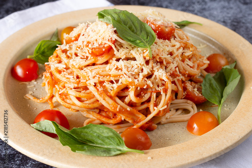 Fresh spaghetti pasta with tomato sauce, basil, and cheese
