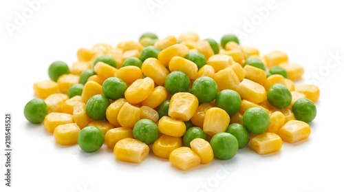 Heap of mixed sweet yellow corn kernels and green peas on white background with mixed vegetables frozen vegetables canned vegetables