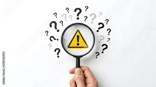warning sign with magnifier and question marks