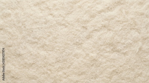 Seamless textured background of cream colored fibrous material