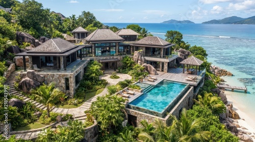 Obraz w ramie Tropical waterfront villa with connected pavilions and elevated rectangular pool
