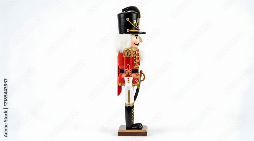 Fototapeta premium Nutcracker figurine standing upright in profile against a clean transparent studio background.