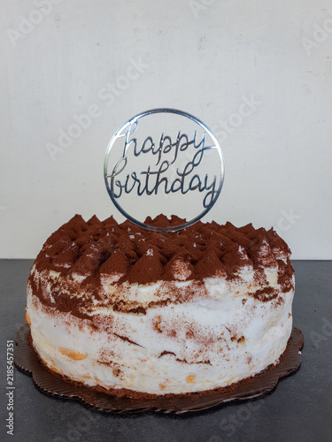 Italian-inspired tiramisu birthday cake with mascarpone cream and an elegant transparent greeting topper