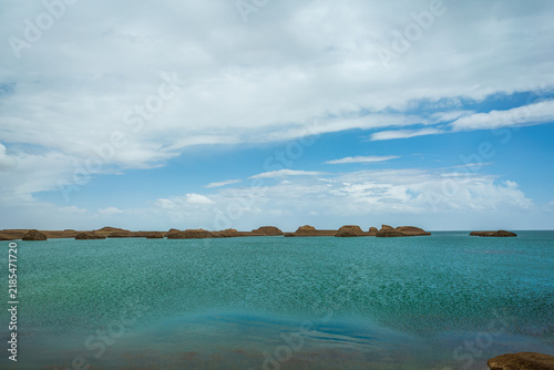 Cuadro en lienzo Qinghai Water Yadan: Turquoise Lake Surrounding Earth Mounds Under Blue Sky and