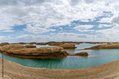 Obraz na plátně Qinghai Water Yadan: Turquoise Lake Surrounding Earth Mounds Under Blue Sky and
