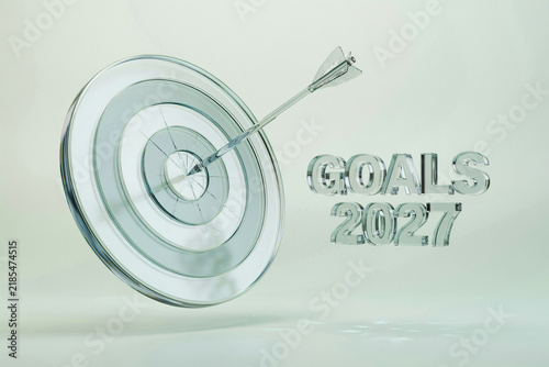 Goals 2027 business concept with glass target and arrow. Strategic planning and future success vision. Transparent 3D text on clean background.