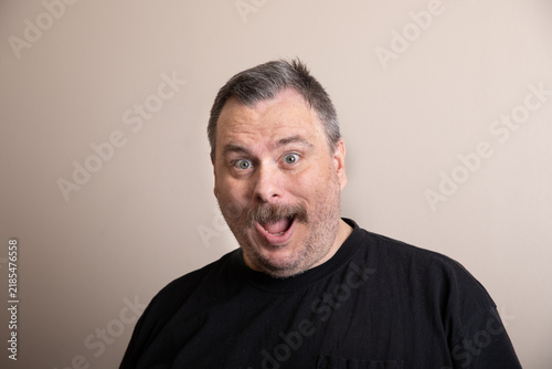 Man displays exaggerated surprised expression