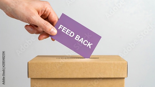 Hand placing feedback card into suggestion box for customer service improvement