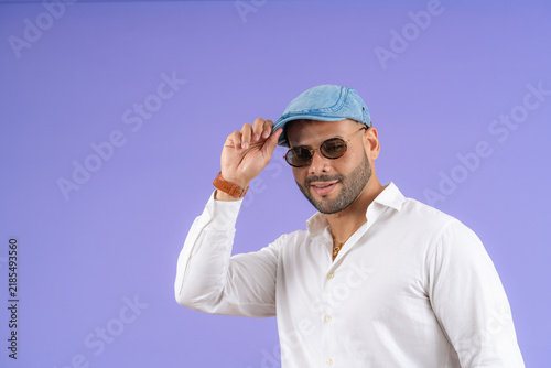 Bild auf Leinwand Young adult man smiling, tipping cap