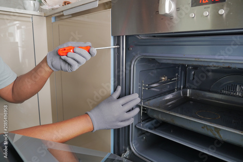 Repairing an oven at home during daylight hours