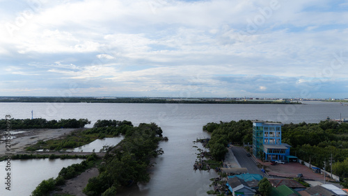 An aerial view of two rivers converging, with a surrounding mangrove forest.