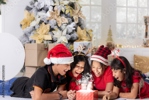фотографія People celebrate Christmas with joy and surprises in a home filled with decorati