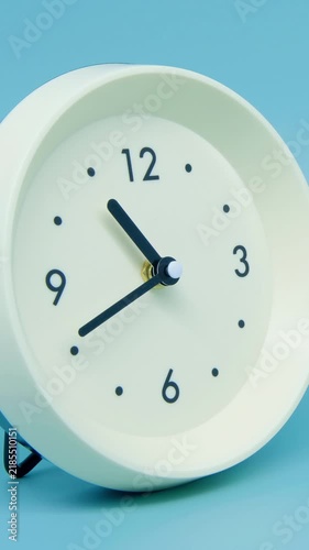 Tme lapse video of a clock time passing over a day to night on blue background.