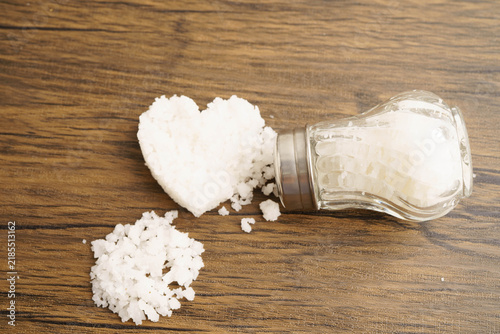 Obraz na płótnie Sodium chloride sea salt with salt shaker.