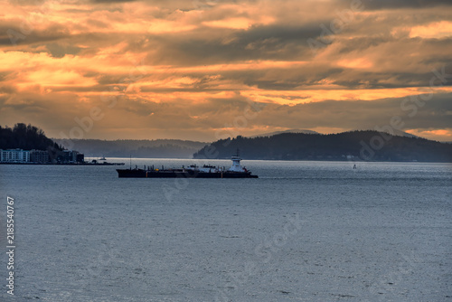 A COMMERCIAL SHIP IN THE PUGET SOUND WITH CALM WATERS AND A NICE SKY NEAR WEST SEATTLE