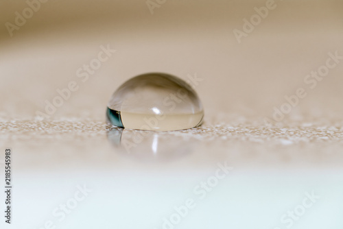Extreme macro of a single water droplet on a smooth surface, purity and clarity concept
