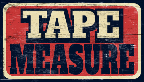 Aged vintage tape measure sign on wood