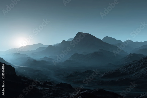 Dramatic View Of Dark Rugged Mountain Ranges Under Blue Hazy Sky At Sunrise