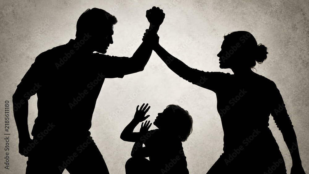 Fototapeta premium A silhouette of a woman stopping a man from hitting a frightened child in domestic conflict.