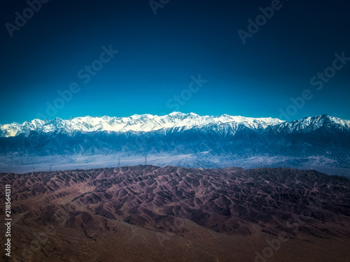 Obraz na plátně Aerial view of Gobi canyon and Qilian snow mountains in suburban Jiayuguan magni