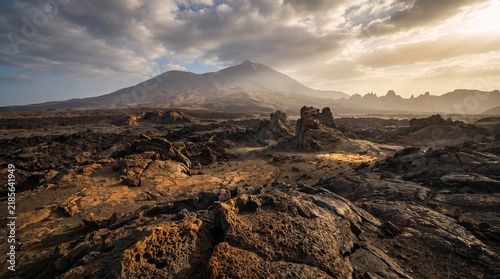 Dramatic Volcanic Landscape with Lava Rock Formations and Distant Mountain
