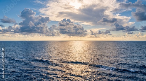 Expansive Open Ocean Seascape Under Dramatic Cloudy Sky at Sunset
