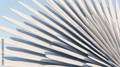 Abstract architectural structure with white radial fins against a clear blue sky background.
