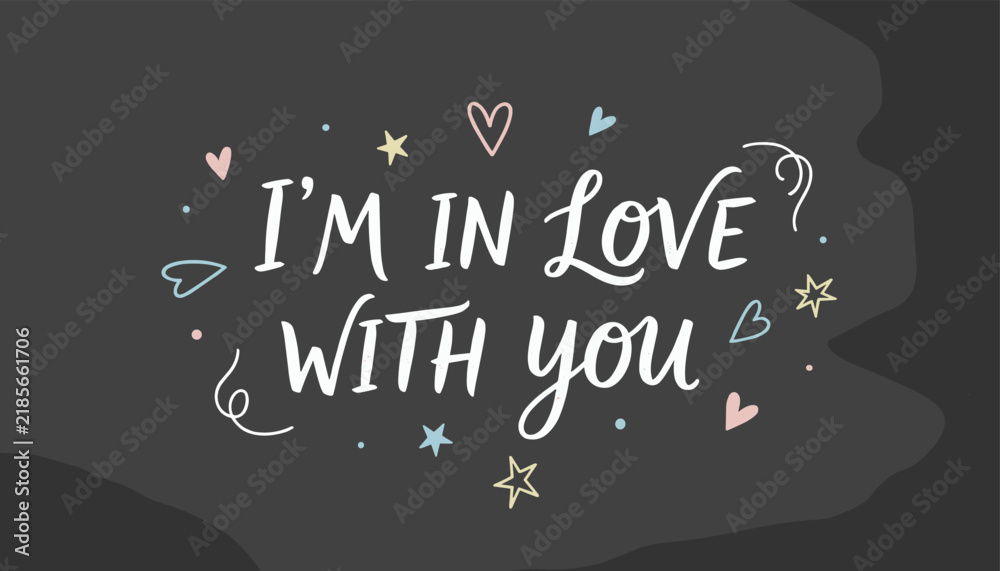 Obraz premium Romantic message saying I'm in love with you is handwritten in chalk with pastel stars and hearts on a blackboard.