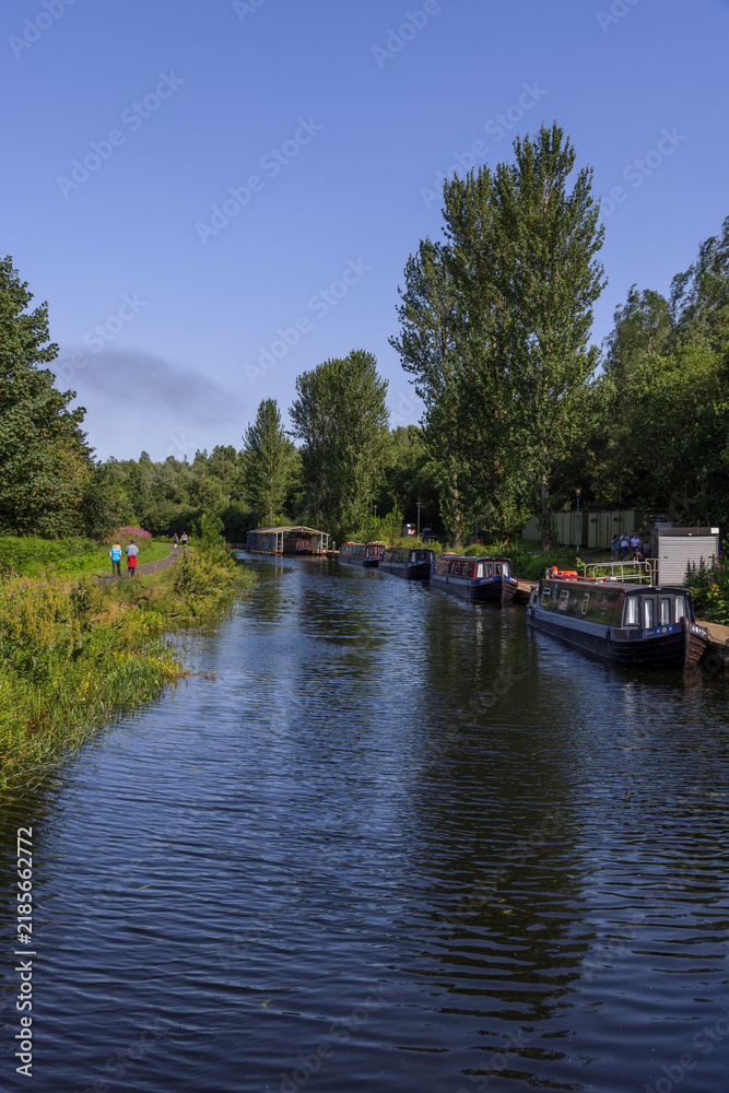 Fototapeta premium The Forth and Clyde Canal near the Falkirk Wheel, a rotating boat lift connecting the Forth and Clyde Canal with the Union Canal in Falkirk, Scotland.