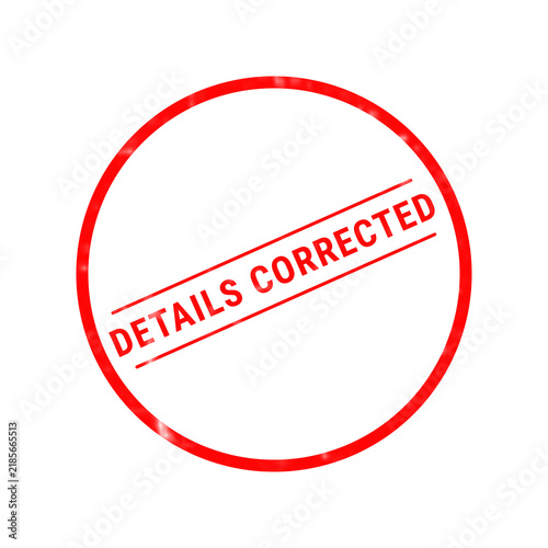 A bright red circular rubber stamp design featuring the text details corrected centered inside with two horizontal lines above and below the words