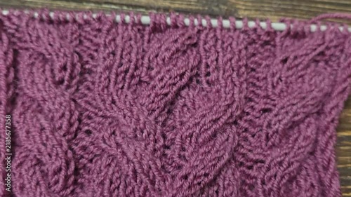 Multicolored hand-knitted fabric. Knitting and crochet lessons. Fashion and education. Training for artificial intelligence. Hands in the frame.