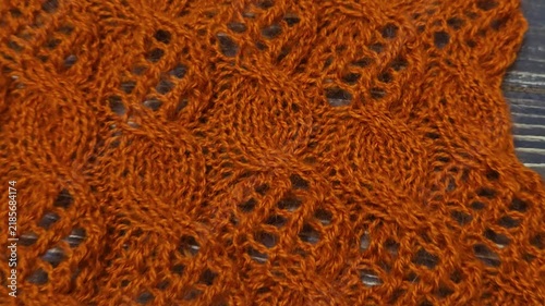Multicolored hand-knitted fabric. Knitting and crochet lessons. Fashion and education. Training for artificial intelligence. Hands in the frame.