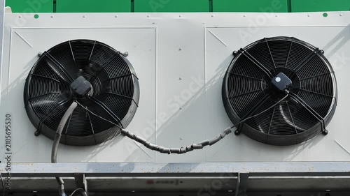Industrial HVAC unit cooling system with fans and visible pareidolia smile