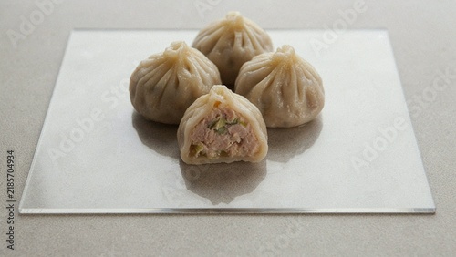 Freshly steamed dumplings with delicate folded pleats, isolated on a transparent background, showcasing a delicious traditional Asian dish.

