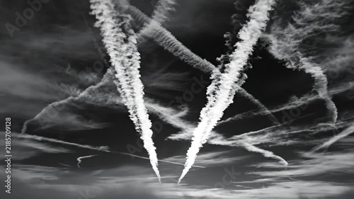 Dramatic black and white aerial view of chemtrails in the atmosphere with detailed wispy cloud formations