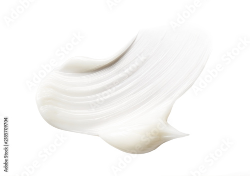 Close-up photo of a smear of creamy lotion on a white background